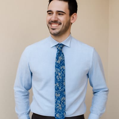 How do you pair a blue floral tie with shirts without pattern overload?